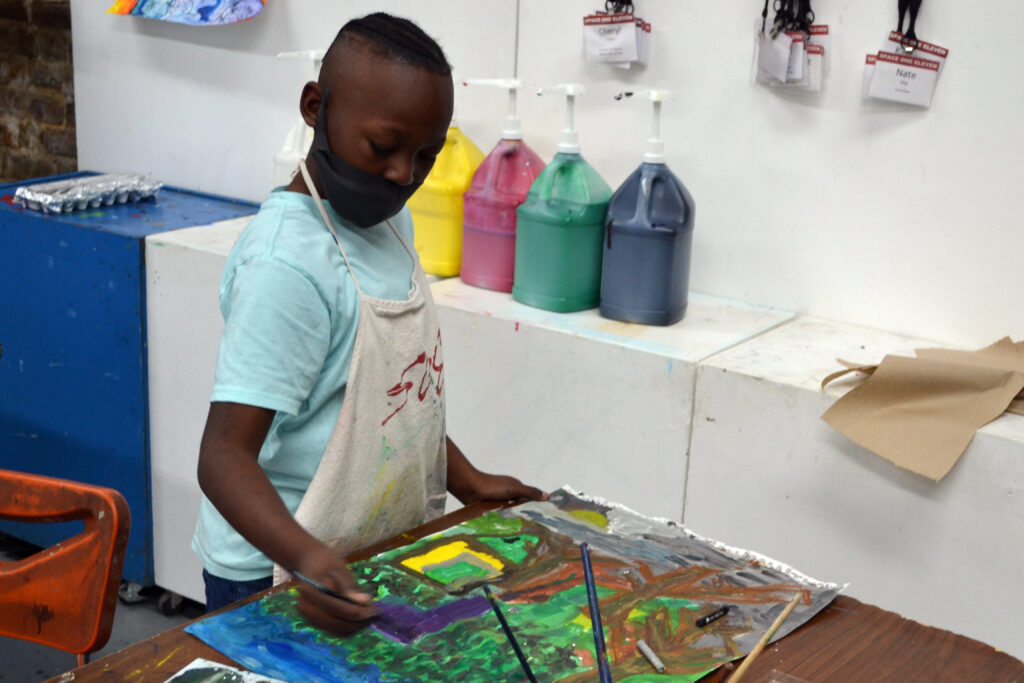 Young Artist working on a landscape painting