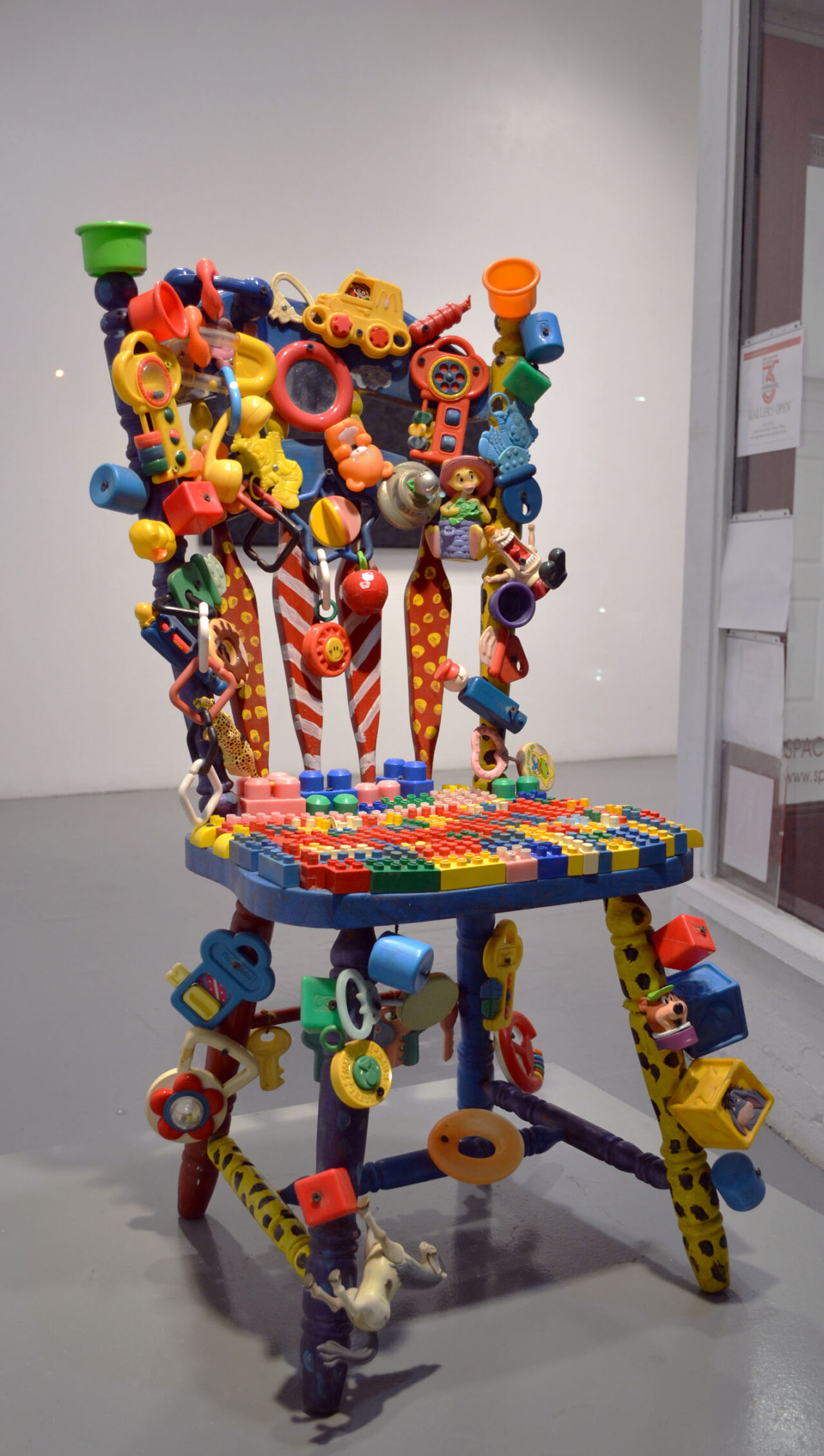 Wooden chair painted and covered with toys