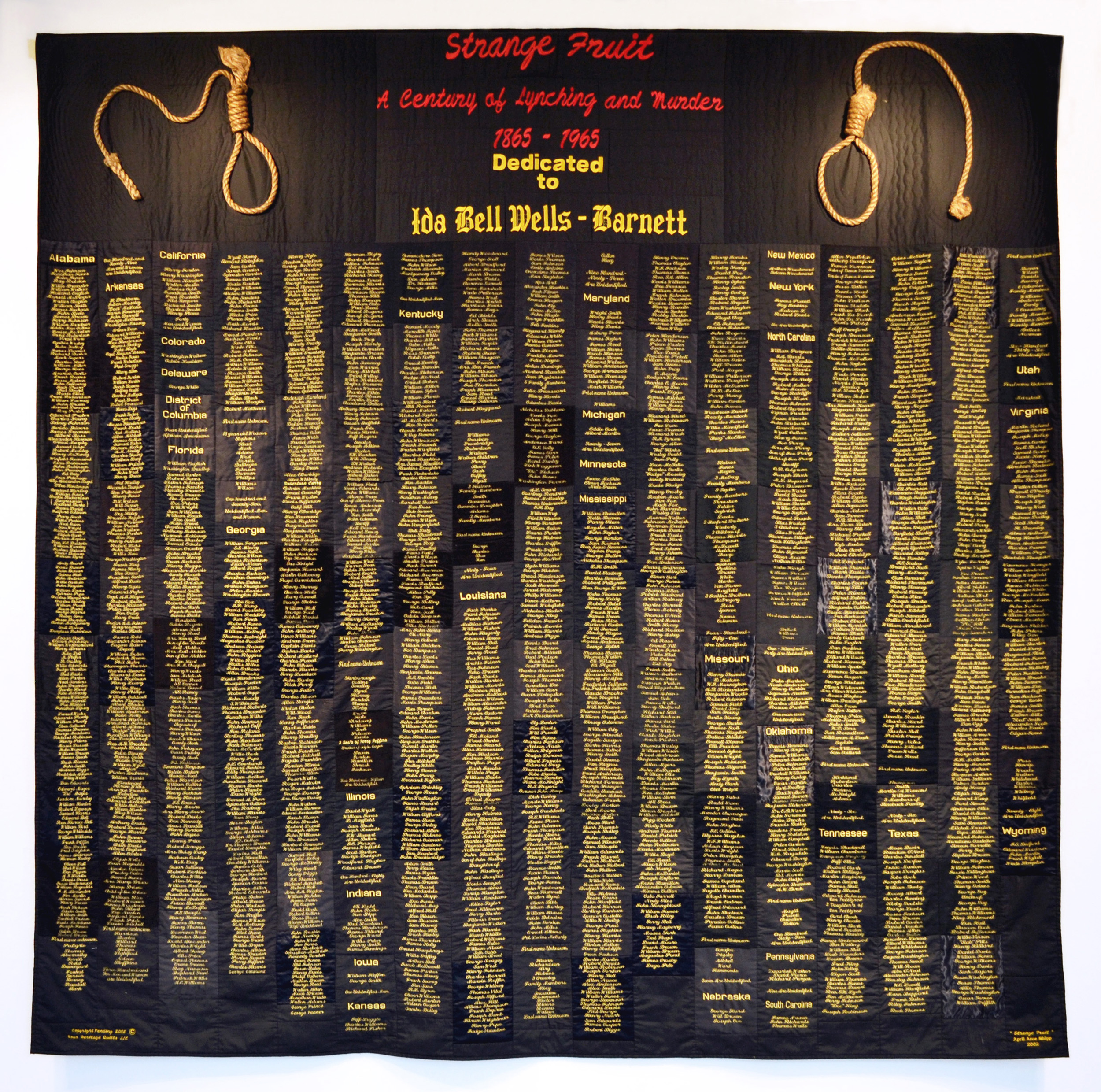 Cropped gallery shot of "Strange Fruit" by April Shipp, Just Injust 2021. Names of lynching victims from1865 to 1965 embroidered in gold on large black quilt with nooses attached to top two corners.