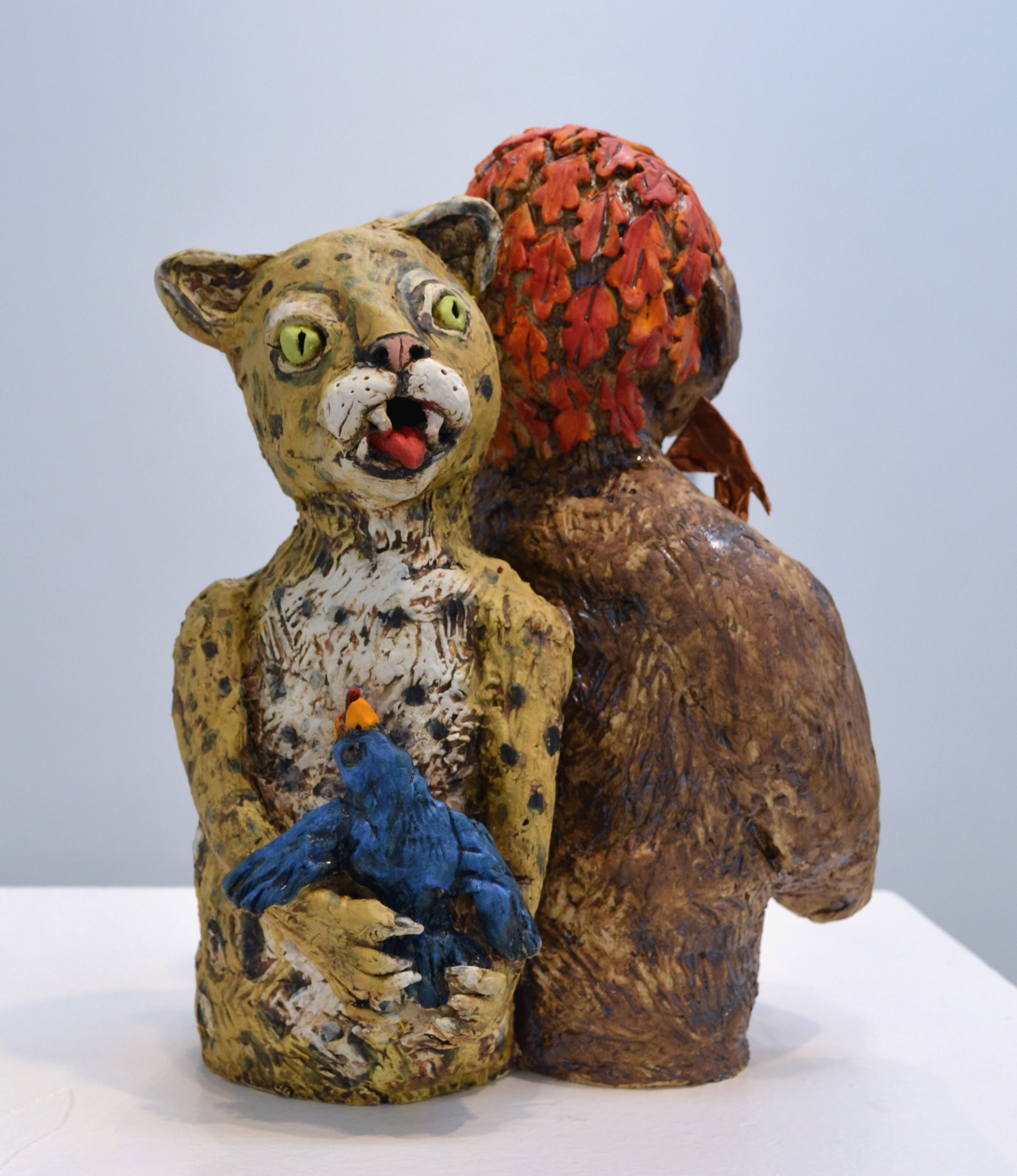 Ceramic man and leopard figures back-to-back